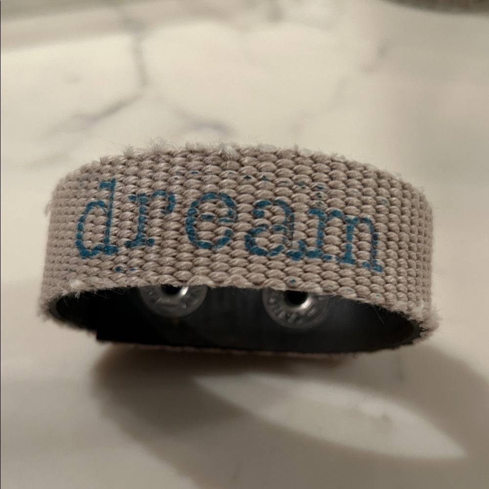 Recycled fire hose bracelet.  Fabric with dream saying.  adjustable snap closure